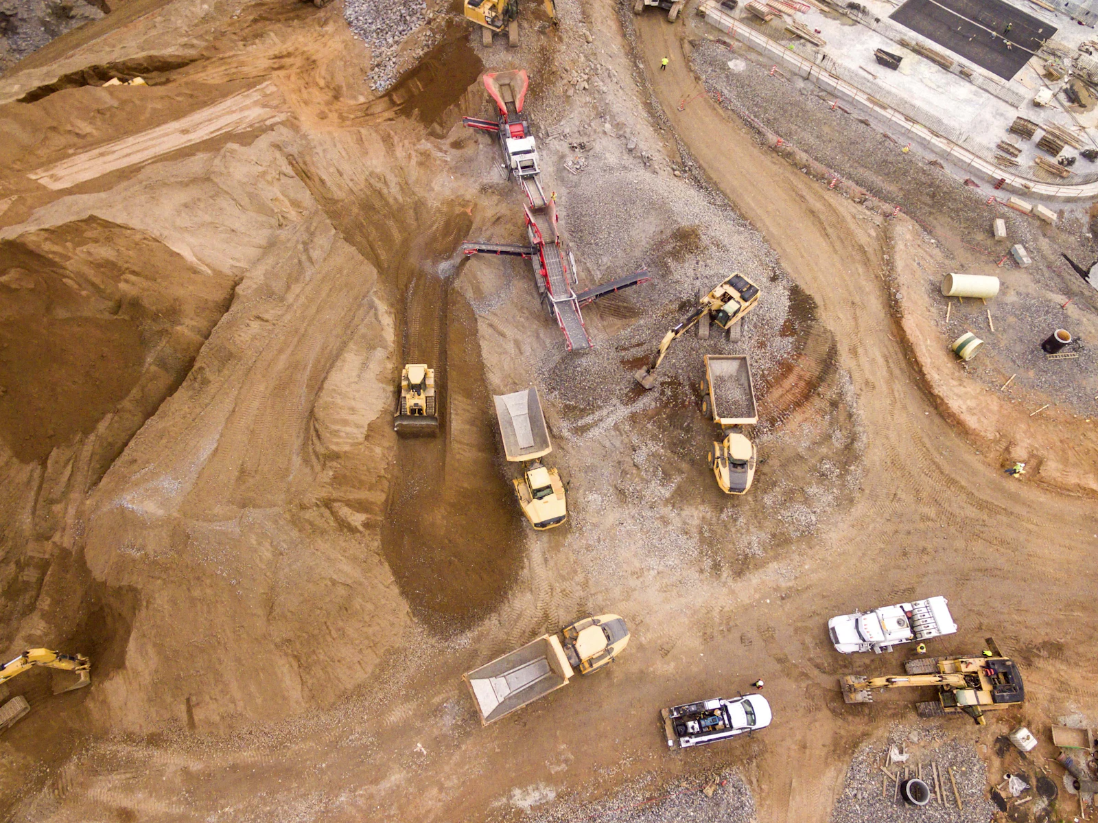 Placeholder photograph of earthworks with haul trucks on a development site