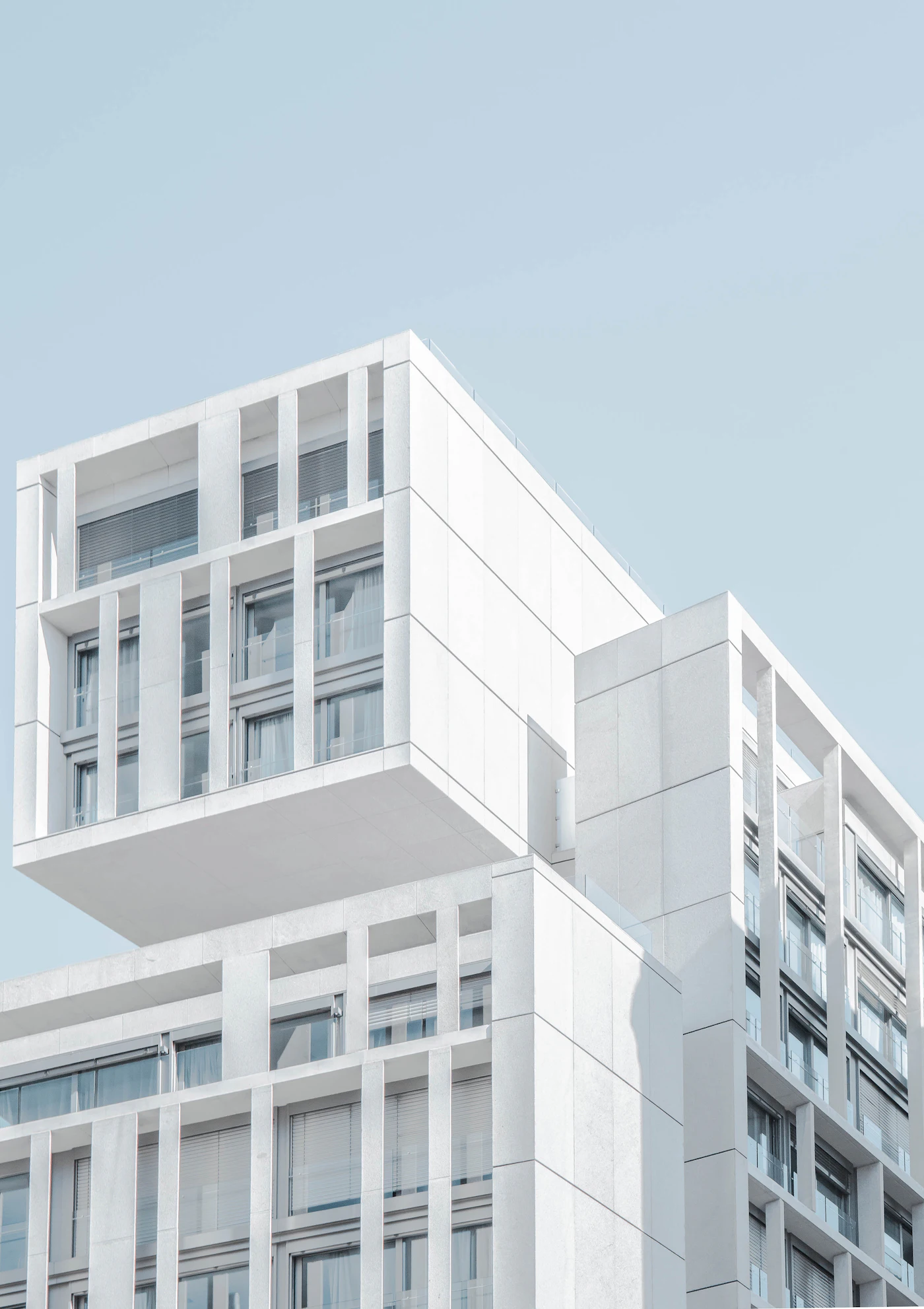 Placeholder photograph of a pale stone commercial building with a cantilevered upper volume